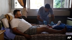 A nurse treats a man who was injured in an Israeli strike in Masyaf, Syria, on Sept. 9, 2024. U.N. officials say unrest related to Israel's fight against Hamas and Hezbollah is one of the factors imperiling the Syrian people.