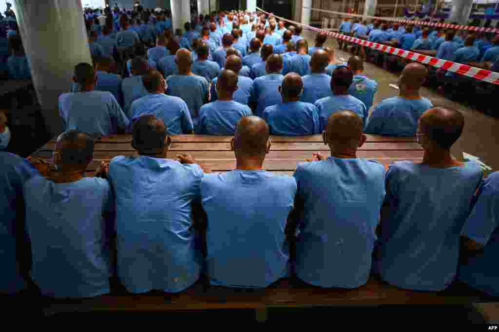 Inmates wait 30 minutes in case they experience side effects after receiving doses of the Sinopharm COVID-19 coronavirus vaccine at Chonburi Central Prison, in Thailand.
