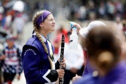 A member of the Waterville Junior/Senior High School marching band is sprayed with mist to prevent heatstroke while participating in a parade during Independence Day celebrations in Washington, July 4, 2019.