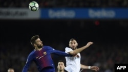 Gerard Piqu, à gauche, et Karim Benzema lors du match entre le FC Barcelona et le Real Madrid CF, Espagne, le 6 mai 2018.