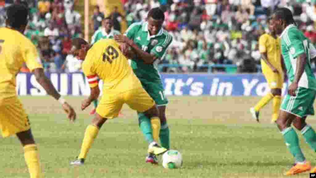 Nigeria&#39;s Victor Moses, right, Mikel John Obi, centre, is challenged by Ethiopia&#39;s Adane Girma, and Aynalem Bancha, left, during their 2014 World Cup qualifying playoff match.