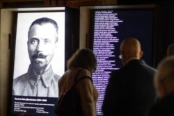 FILE - Visitors look at an exposition at the opening of the Gulag history museum in Moscow, Russia, Oct. 30, 2015.