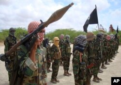 FILE - Al-Shabab fighters display weapons as they conduct military exercises in northern Mogadishu, Somalia, on October 21, 2010.