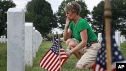 Anita Dixon, of Wichita, Kansas, visits the burial site of her son Army Sgt. Evan Parker. He was killed while serving in Iraq in 2005.