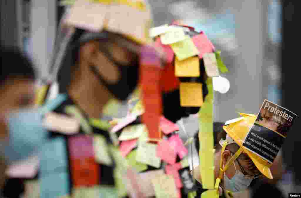 Demonstrators wear post-it notes as part of the &#39;Lennon Wall&#39; movement during a protest against the recent violence in Yuen Long, at Hong Kong airport, China.