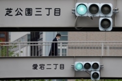 A man wearing a protective face mask is seen on a walkway in Tokyo, following the outbreak of the coronavirus disease (COVID-19), Tokyo, Japan, May 4, 2020.