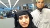 This July 27, 2014 photo provided by U.S. Customs and Border Protection shows Tashfeen Malik, left, and Syed Farook, as they passed through O'Hare International Airport in Chicago.