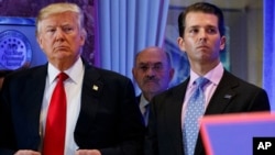 FILE - former President Donald Trump, left, his chief financial officer Allen Weisselberg, center, and son Donald Jr.