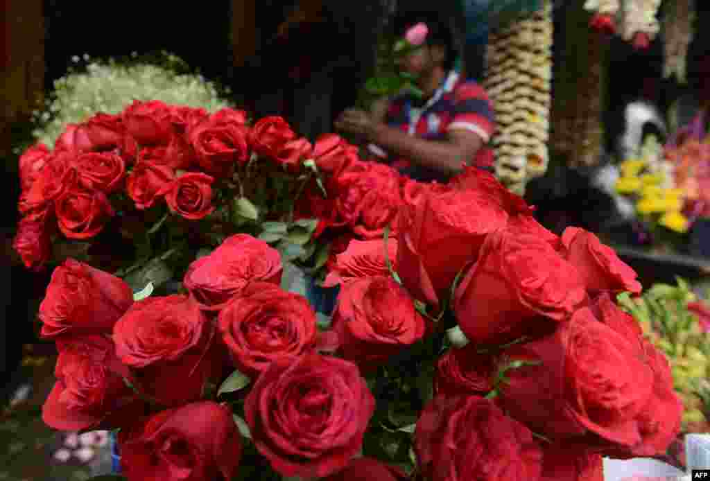 An Indian flower seller arranges varieties of roses at a roadside stall ahead of Valentine&#39;s Day in Siliguri. Despite opposition from some right-wing groups who see the day as counter to traditional Indian culture, Valentine&#39;s Day is celebrated in India as Rashtriya Prem Divas.