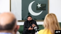 FILE - Pakistan's Interior Minister Sheikh Rashid Ahmed speaks to reporters at the Pakistani embassy in Kuwait City, May 31, 2021.