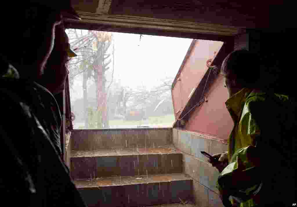 Police, rescue workers, and other local media gather in a storm shelter to ride out another threatening storm as it approaches areas already damaged by an earlier tornado in Athens, Alabama. (AP)