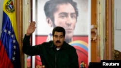 Venezuela's President Nicolas Maduro gestures during a meeting with the opposition's newly elected mayors and governors at Miraflores Palace in Caracas, Dec. 18, 2013.