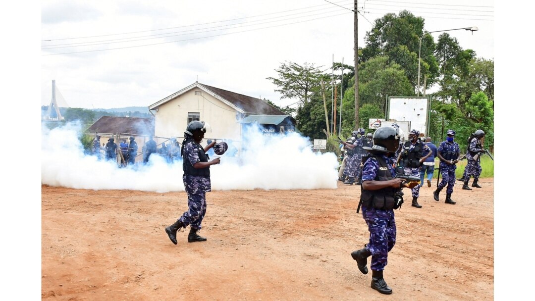 Ugandan riot policemen fire tear gas canisters to disperse supporters of presidential candidate Robert Kyagulanyi, also known as Bobi Wine, in Luuka district, eastern Uganda, Nov. 18, 2020.