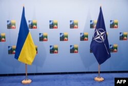 Bendera Ukraina (kiri) dan NATO terlihat di sela-sela KTT NATO di Vilnius pada 12 Juli 2023. (Foto: AFP)