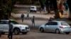 FILE - Few cars and residents are seen in the normally busy streets of Yeoville, downtown Johannesburg, South Africa, April 10, 2020. 