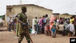 A Soldier stand guard as voters cast their vote during the gubernatorial election in Kaduna, Nigeria, Thursday, April 28, 2011. Two states in Nigeria's Muslim north voted Thursday for state gubernatorial candidates after their polls were delayed by viol