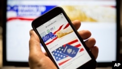 In this photo taken July 15, 2018, the USAReally website is seen on an iPhone screen in Moscow, Russia. The site appears oddly amateurish and obviously Russian, with grammatical flubs and links to Russian social networks.