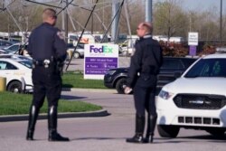 Police stand near the scene where multiple people were shot at the FedEx Ground facility early Friday morning, April 16, 2021, in Indianapolis. A gunman killed eight people and wounded several others…