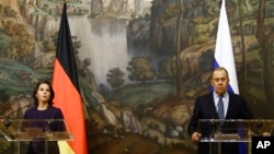 Russian Foreign Minister Sergey Lavrov and German Foreign Minister Annalena Baerbock, left, attend a joint news conference following their talks in Moscow, Jan. 18, 2022.