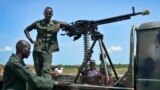 FILE - Government soldiers stand guard by their vehicle on the front lines in the town of Kuek, northern Upper Nile state, South Sudan, Aug. 19, 2017.