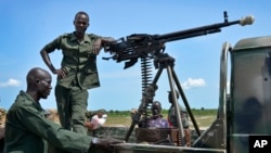 FILE - Government soldiers stand guard by their vehicle on the front lines in the town of Kuek, northern Upper Nile state, South Sudan, Aug. 19, 2017.