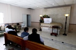 Family and friends attend the wake of a person who died during a gunbattle in Villa Union, Mexico, Dec. 2, 2019.