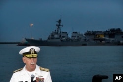 Commander of the U.S. Pacific Fleet, Scott Swift answers questions during a press conference with the USS John S. McCain and USS America docked in the background at Singapore's Changi naval base on Aug. 22, 2017 in Singapore.