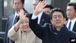 FILE - Japan's Prime Minister Shinzo Abe and his wife, Akie Abe, wave as the emperor and empress depart for Vietnam, Feb. 28, 2017. Akie Abe denies making a donation to a school at the heart of a political scandal.