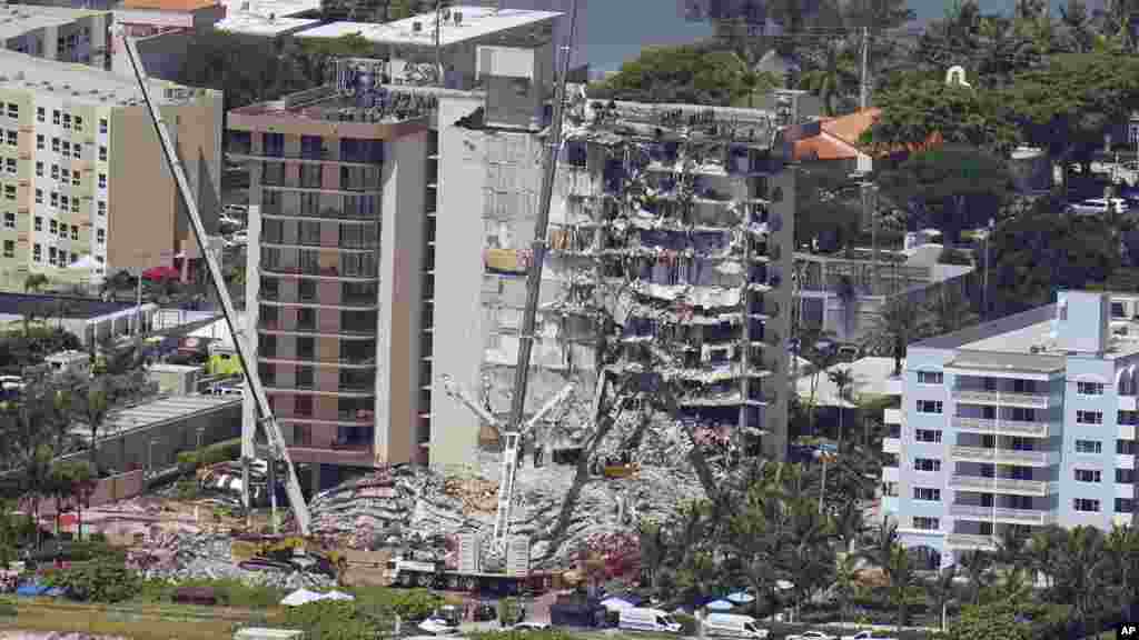 Spasioci u Surfsajdu kod Majamija nastavili su potragu za 156 nestalih u ruševinama stambene zgrade, koja se srušila pre tri dana. Zvaničan razlog urušavanja nije poznat, ali je sve više pitanja o strukturalnim oštećenjima zgrade i propustima nadležnih. Broj mrtvih porastao je na devet. 27. juni, 2021. ( Foto: Džerald Herbert / AP )