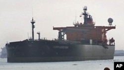 FILE - An oil tanker passes through the Suez Canal in Ismailia, Egypt.