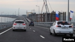 Cars drive along a bridge, which was constructed to connect the Russian mainland with the Crimean peninsula across the Kerch Strait, May 16, 2018. Russia annexed Crimea from Ukraine in 2014.