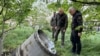 In this photo provided by the Odesa Regional Administration, city officials examine a fragment of a missile after the Russian missile attack that killed several people, and wounded multiple others in Odessa, Ukraine, April 29, 2024. 