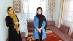 Shamsia Alizada, 18, right, who has come in at the top in her country's university entrance exams, stands beside her mother after an interview at her home in Kabul, Afghanistan, Sept. 25, 2020.