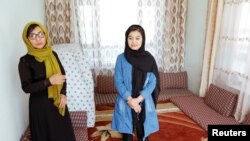 Shamsia Alizada, 18, right, who has come in at the top in her country's university entrance exams, stands beside her mother after an interview at her home in Kabul, Afghanistan, Sept. 25, 2020.