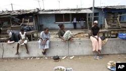 Market vendors display their meager stock of available goods at a street market in the Youpougon neighborhood of Abidjan, April 9, 2011