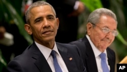 FILE - President Barack Obama, left, listens to a live band along with Cuba's President Raul Castro during a state dinner at the Palace of the Revolution in Havana, Cuba, March 21, 2016. 