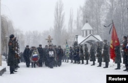 Honour guards stand at attention during the funeral ceremony of Oleg Peshkov, a Russian pilot of the downed SU-24 jet, at a cemetery in Lipetsk, Russia, December 2, 2015.