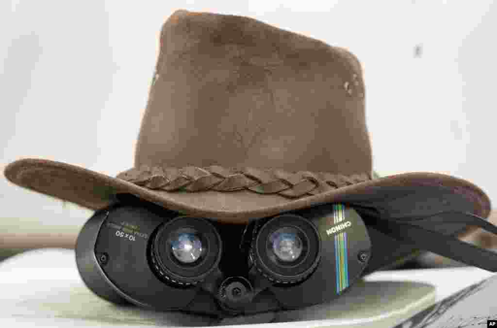 A pair of binoculars are covered by a hat at tea on the first day of the opening Ashes series cricket match between England and Australia at Trent Bridge cricket ground, Nottingham, England. 