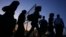 FILE - Migrants from Syria walk into a refugee camp in Kokkinotrimithia village outside the capital Nicosia, Cyprus.