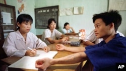 Doctors at a drug rehabilitation clinic check for any signs that Ha Van Canh, 19, has been injecting himself with drugs in this file photo taken on July 30, 1997.