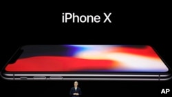 Apple CEO Tim Cook announces the new iPhone X at the Steve Jobs Theater on the new Apple campus, Tuesday, Sept. 12, 2017, in Cupertino, Calif. (AP Photo/Marcio Jose Sanchez)