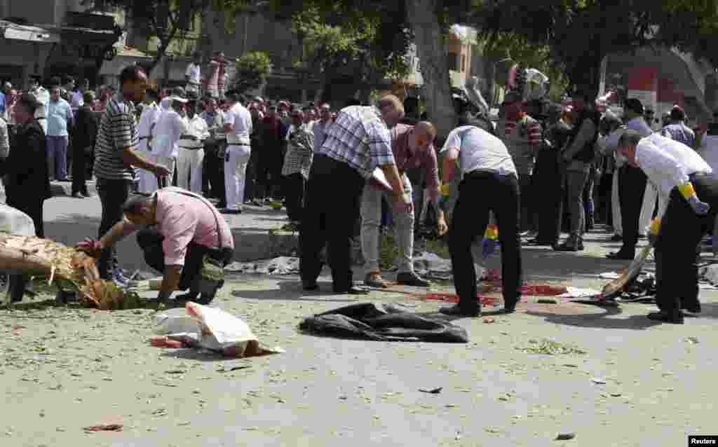 Forensic workers and policemen carry out investigations at the scene of a bomb blast in Cairo.