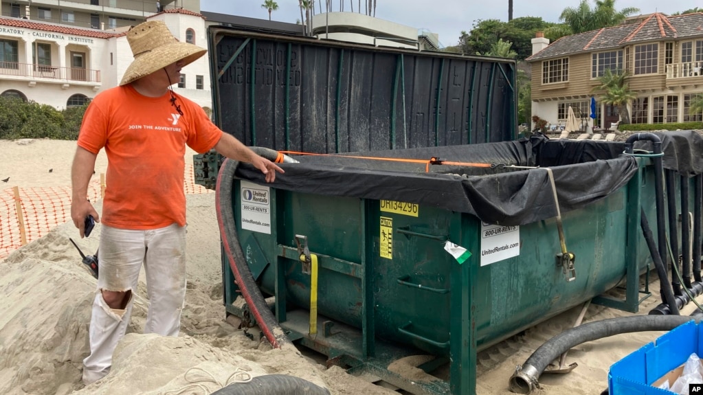 Marine scientist Robert Mooney shows a tank that some of an invasive algae was being pumped into from the harbor in Newport Beach, Calif., Wednesday, July 7, 2021.