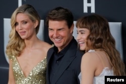 Actor Tom Cruise arrives with Annabelle Wallis, left, and Sofia Boutella for the premiere of the film "The Mummy" in New York, June 6, 2017.