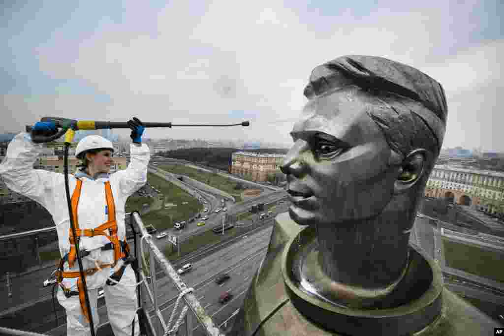 A worker cleans the statue of Russian astronaut Yuri Gagarin, the first person who flew to space, ahead of Cosmonautics Day, which is celebrated on April 12, in Moscow, Russia.