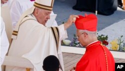 Newly elected Cardinal Robert Francis Prevost, Prefect of the Dicastery for Bishops, right, receives his biretta from Pope Francis as he is elevated in St. Peter's Square at the Vatican on Sept. 30, 2023.