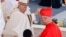 Newly elected Cardinal Robert Francis Prevost, Prefect of the Dicastery for Bishops, right, receives his biretta from Pope Francis as he is elevated in St. Peter's Square at the Vatican on Sept. 30, 2023.