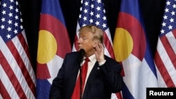 U.S. Republican presidential nominee Donald Trump puts his hand to his ear as he speaks at a campaign rally in Pueblo, Colorado, Oct. 3, 2016. 