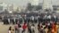 Protesting Bangladeshi garment workers throw stones at police near the international airport in Dhaka, Bangladesh, Sunday, Dec. 12, 2010. They were demanding the implementation of a new minimum wage.