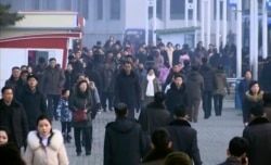 In this image made from video, pedestrians brave the cold as the make their way through an open square, Jan. 30, 2020, in Pyongyang, North Korea.